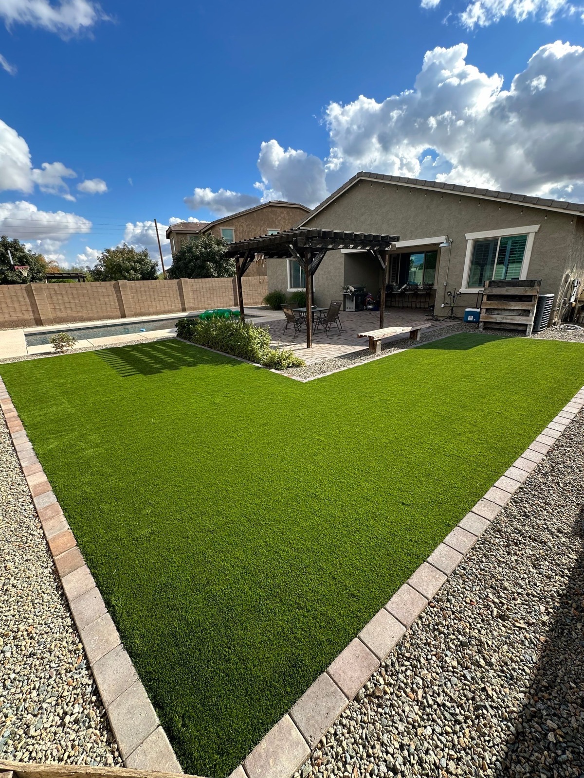 Backyard artificial turf, pavers, and patio cover installation in Tempe, Arizona by Green Forever Arizona