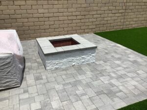 fire pit area with pavers and artificial turf